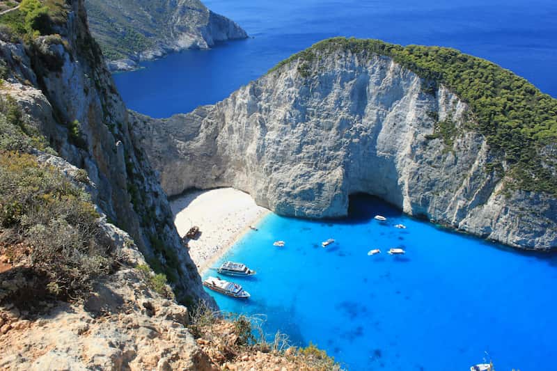 Zakynthos island is one of the beautiful places to visit in Greece. and explore the thousand foot white cliffs, turquoise water, remnants of a wrecked ship, blue caves and impressive viewpoints. 